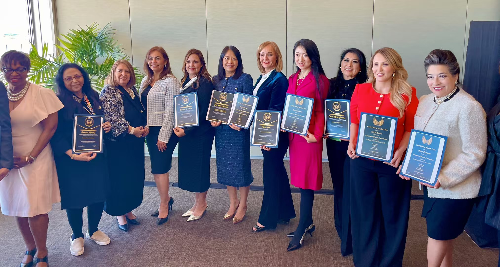 Women leaders holding recognition certificates at an international leadership event